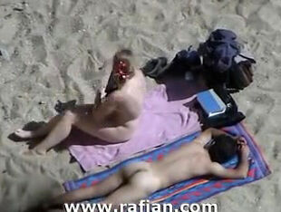 African and milky femmes sunbathing on bare beach
