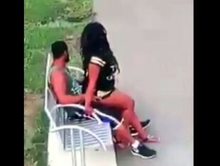 Ebony duo romps on park bench not knowing that they are
